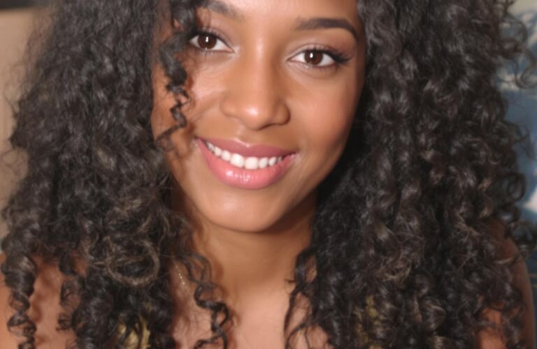 Natural curly hair styled without heat on smiling woman face