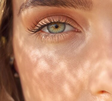 Close-up photograph of a woman with fresh natural eye makeup.