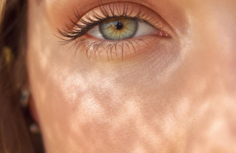 Close-up photograph of a woman with fresh natural eye makeup.