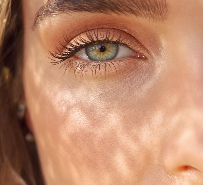 Close-up photograph of a woman with fresh natural eye makeup.